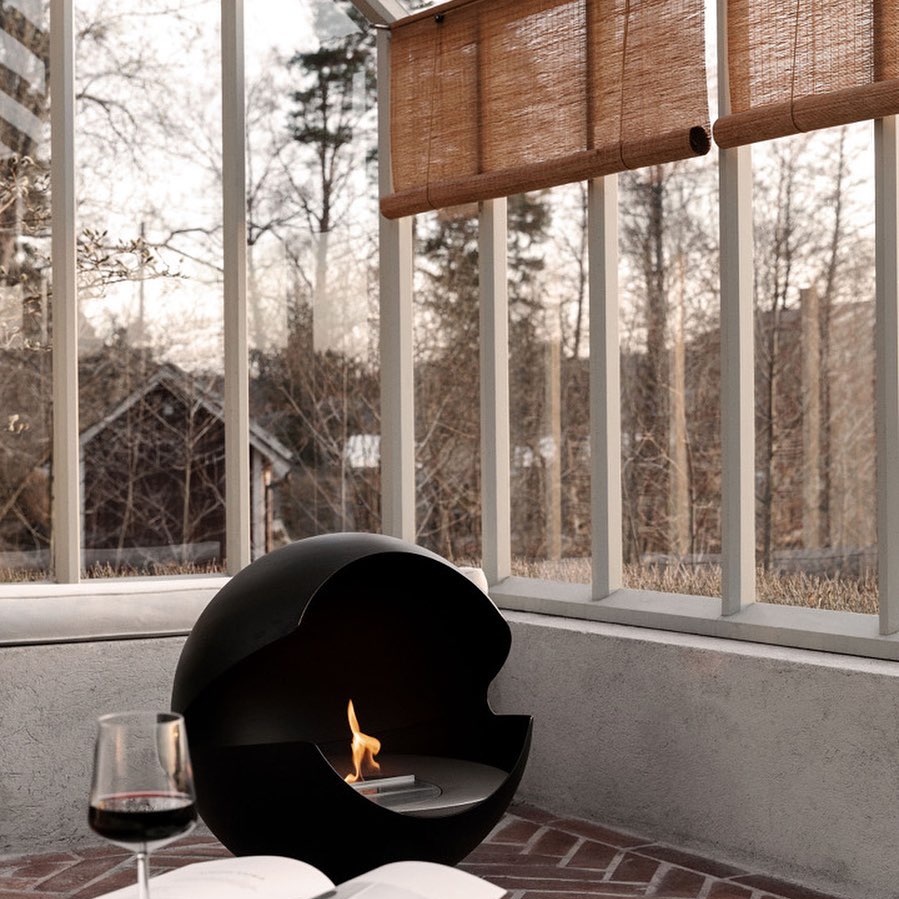 Chimenea Vauni de diseño escandinavo en terraza con textiles naturales